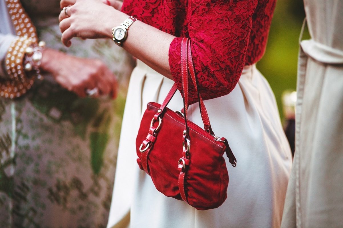 model with a red handbag