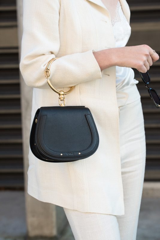 lady holding a small black handbag